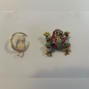 Vintage rhinestone pins. Cat in the moon pin and colorful frog pin.